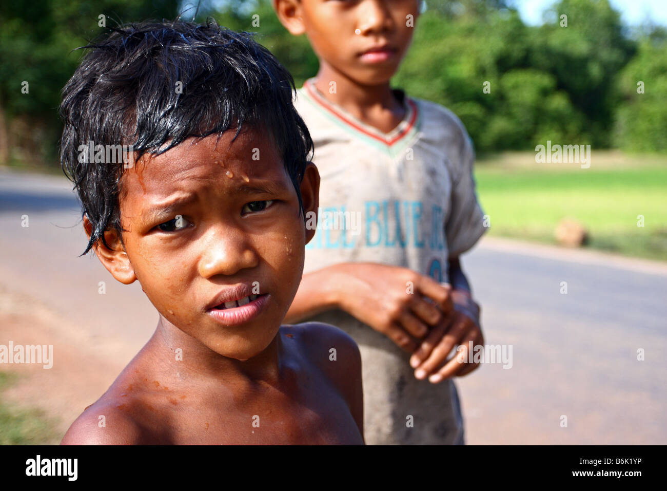Portrait of a local Cambodian kid with a sad face in the streets arond Angkor Wat, Siem Reap Cambodia Stock Photo