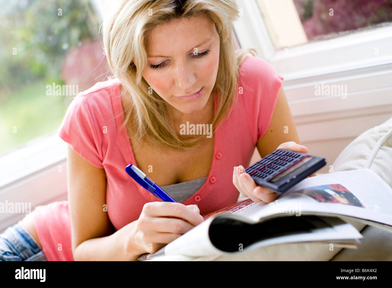 Woman working out finances Stock Photo