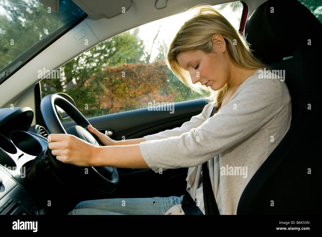 Woman falling asleep whilst driving Stock Photo