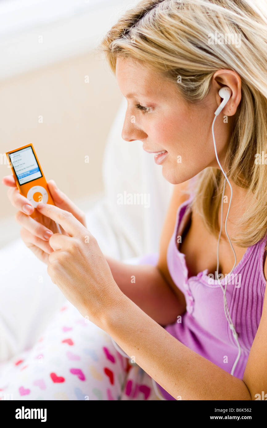 Girl listening to 'iPod Nano' Stock Photo