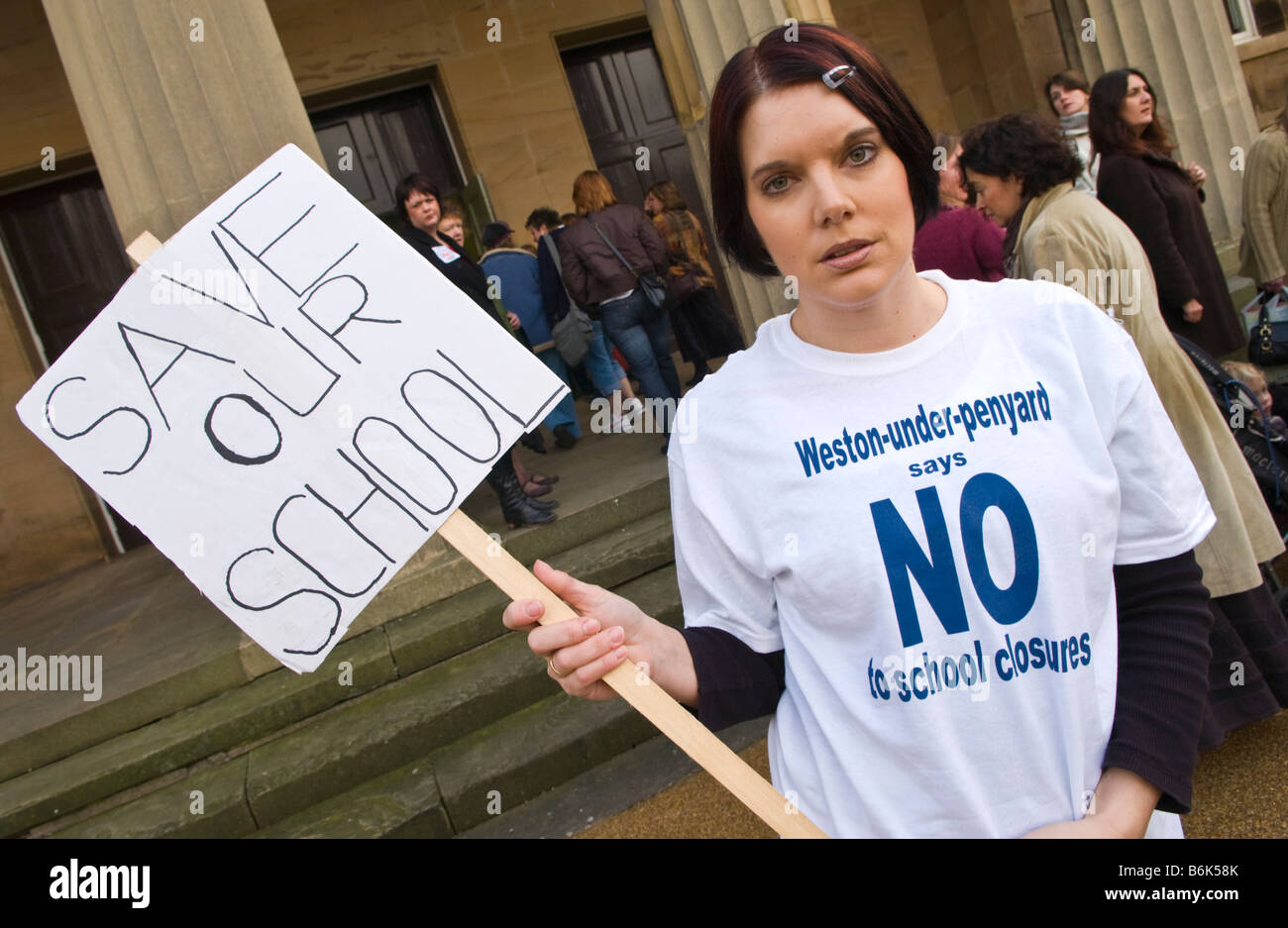 Members of the public protest outside a council meeting in Herefords Shirehall to discuss school closures in the county Stock Photo