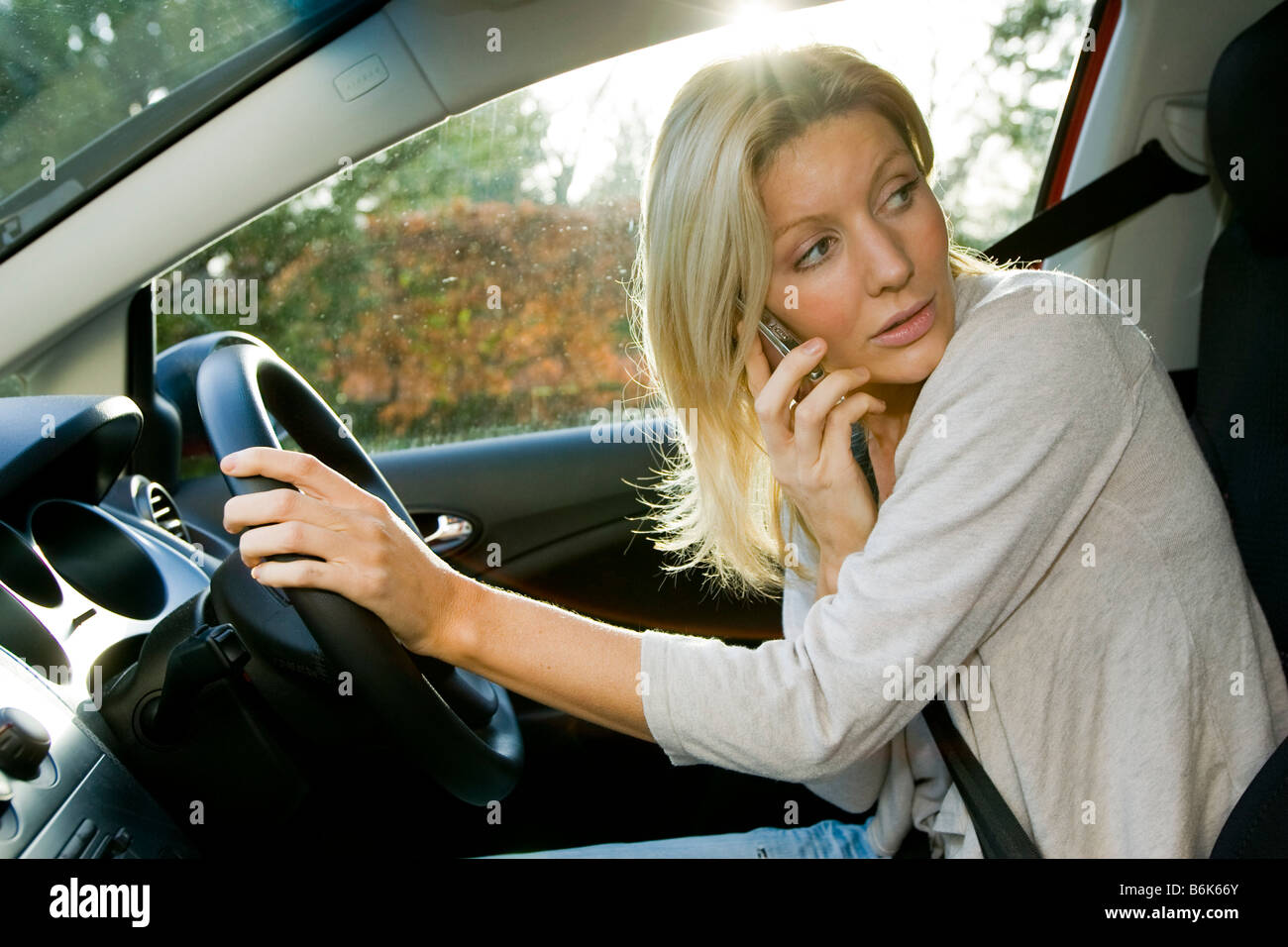 Woman talking on phone in car Stock Photo