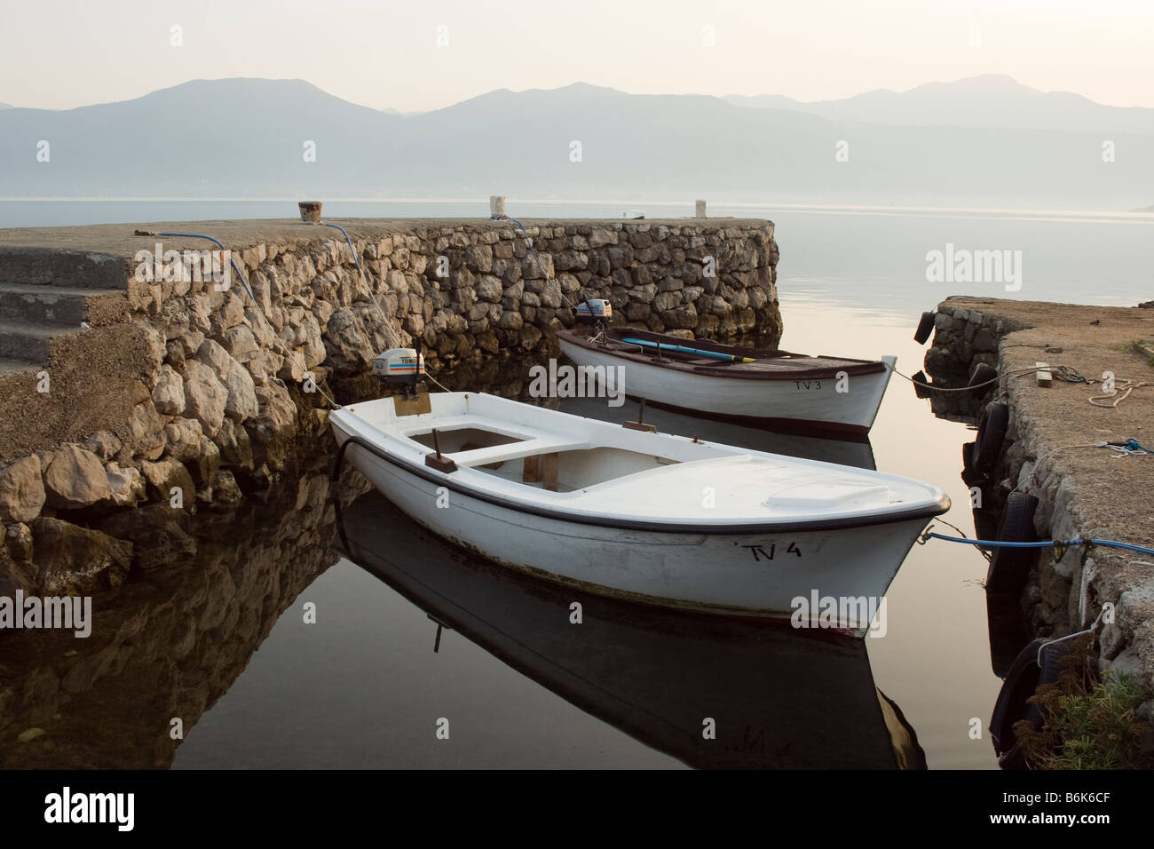 two wooden boats in a little bay in the morning, Kotor, Montenegro Stock Photo