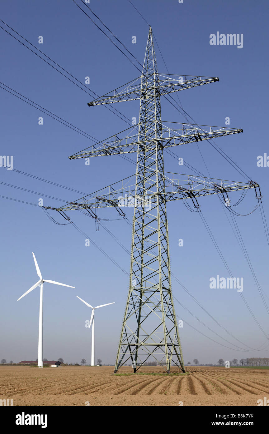high voltage transmission pylon and windmills Stock Photo - Alamy