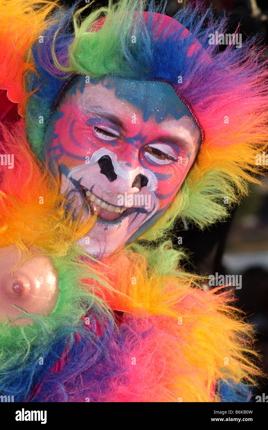clown south american style street artist theatre kaleidoscope multi colored coloured rainbow face painted monkey thames festival Stock Photo