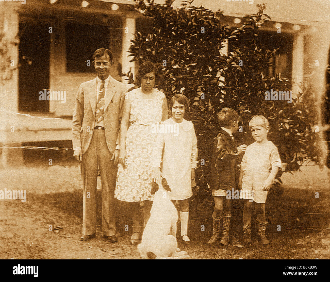 retro photo of family and dog circa 1927 Stock Photo