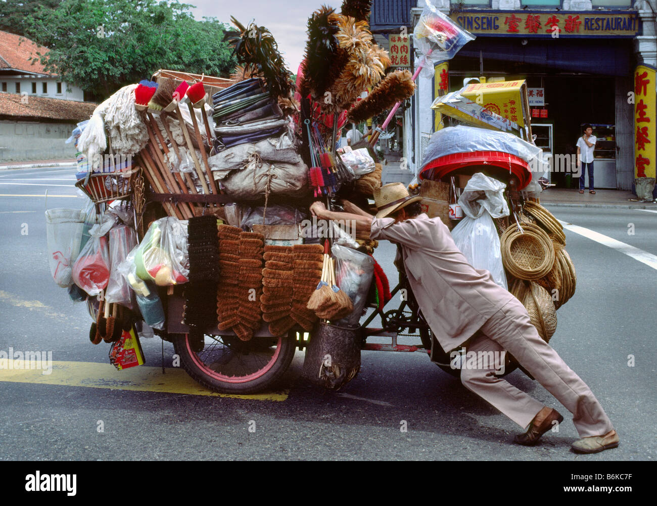 Peddler pushing heavy load in Singapore 2 Stock Photo