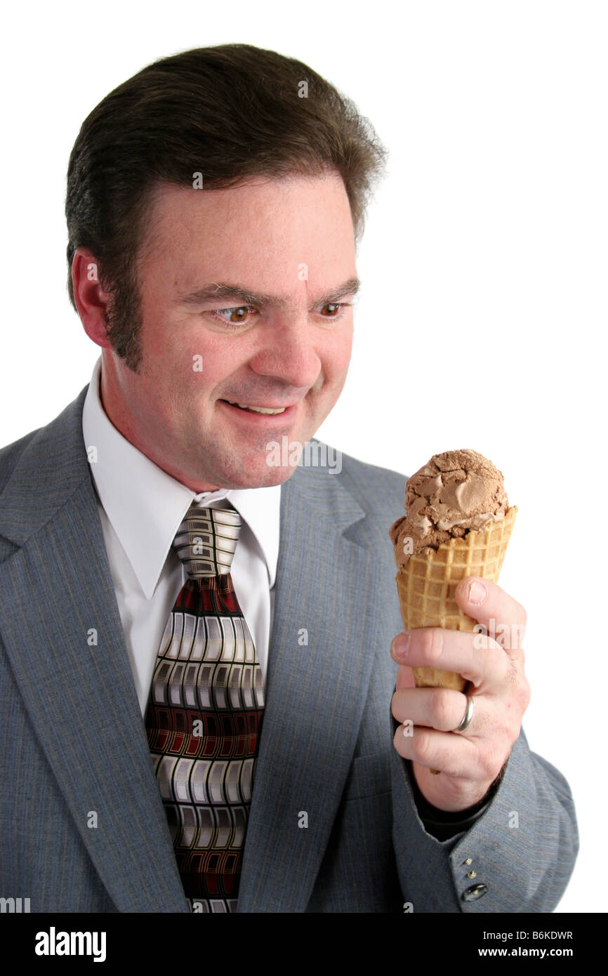 A handsome businessman looking excitedly at a chocolate ice cream cone Stock Photo