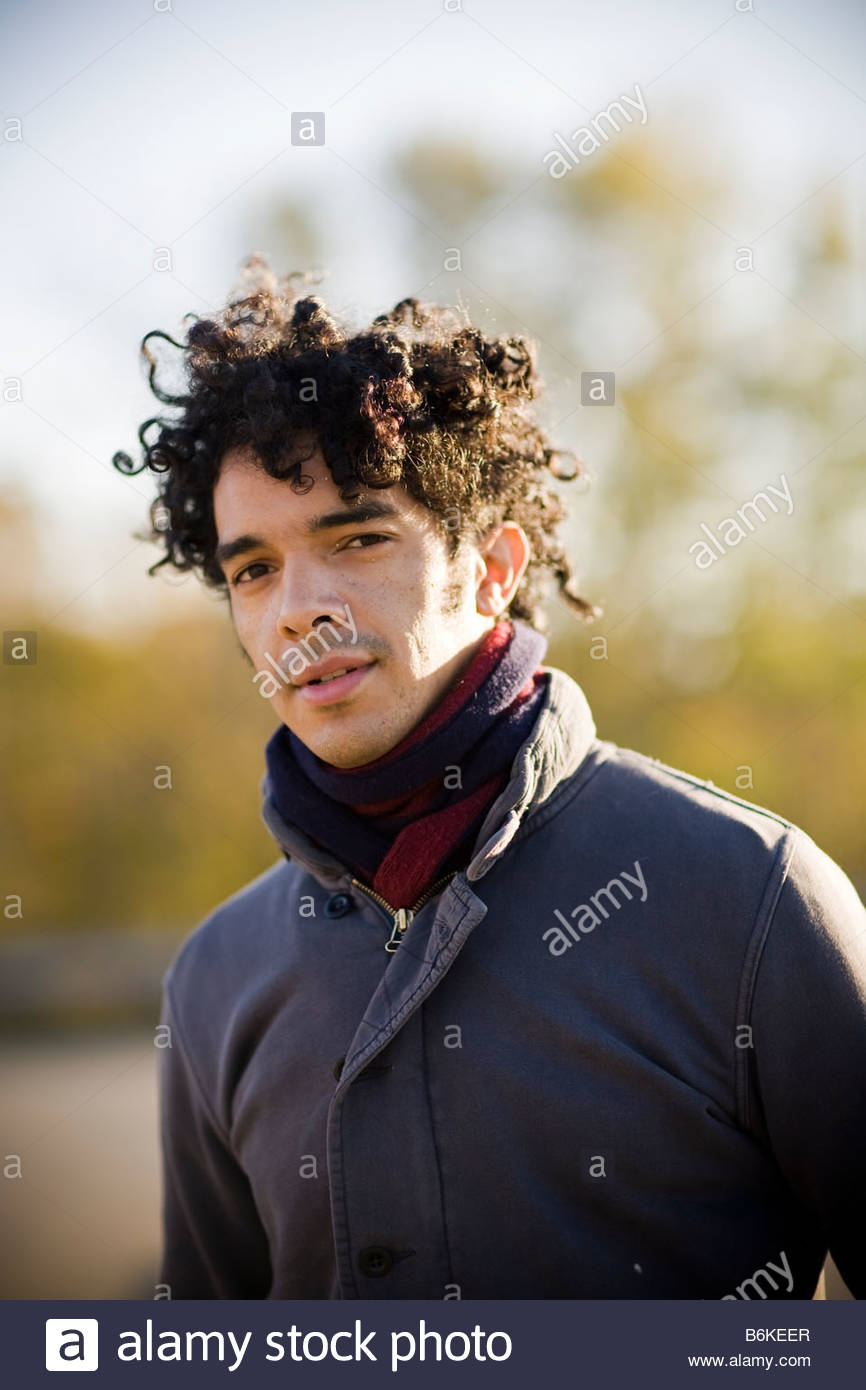 Young Handsome Black Man With Curly Hair Outside At Sunset