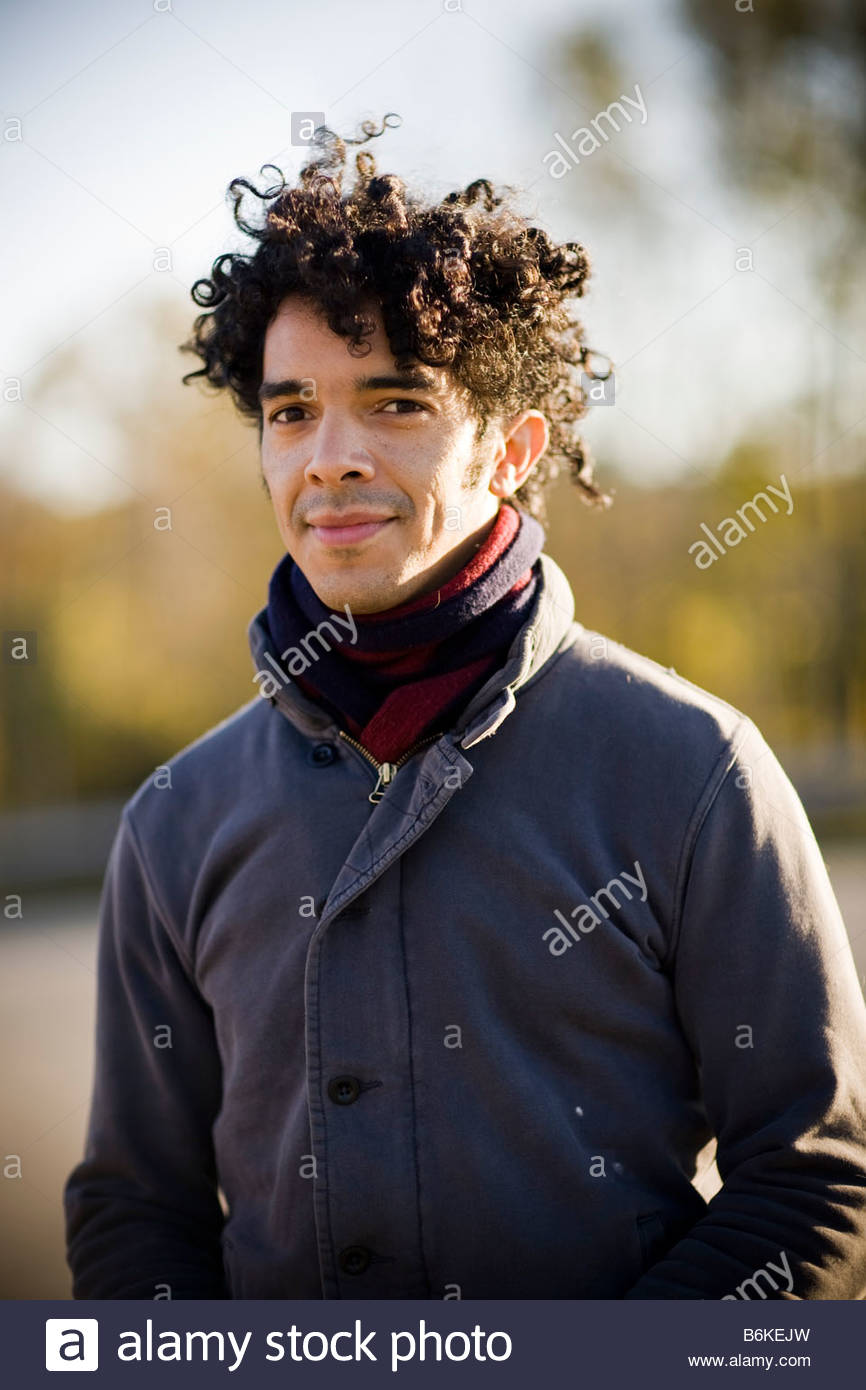 Young Handsome Black Man With Curly Hair Outside At Sunset