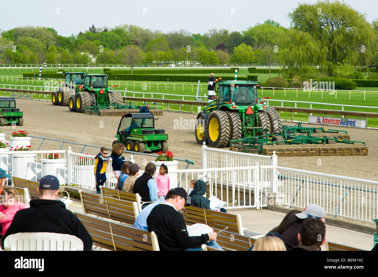 Synthetic turf at horse race track being groomed by tractors Stock