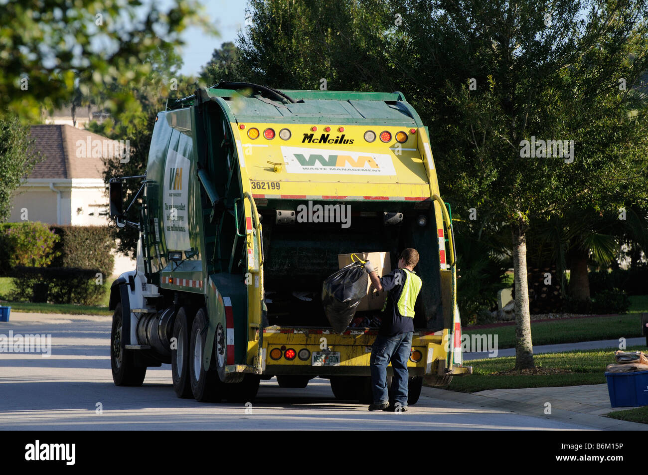 Garbage collection truck and operative Florida USA Stock Photo Alamy