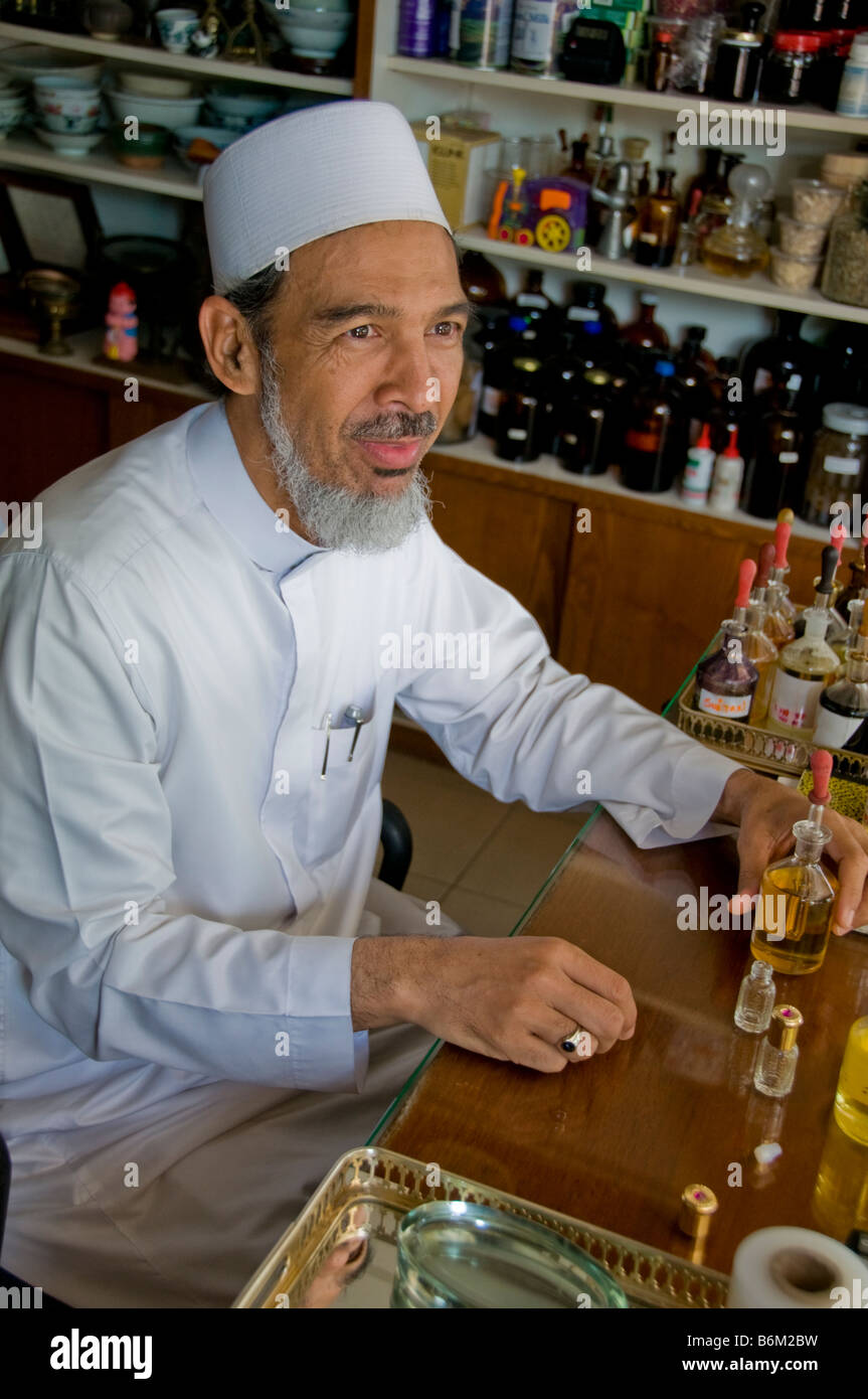 Distinguished older Muslim man in perfume shop in Arab quarter Singapore Stock Photo