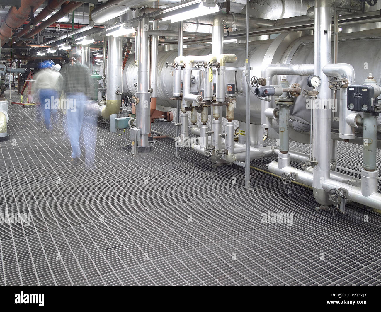 Workers walking through industrial power plant, USA Stock Photo - Alamy
