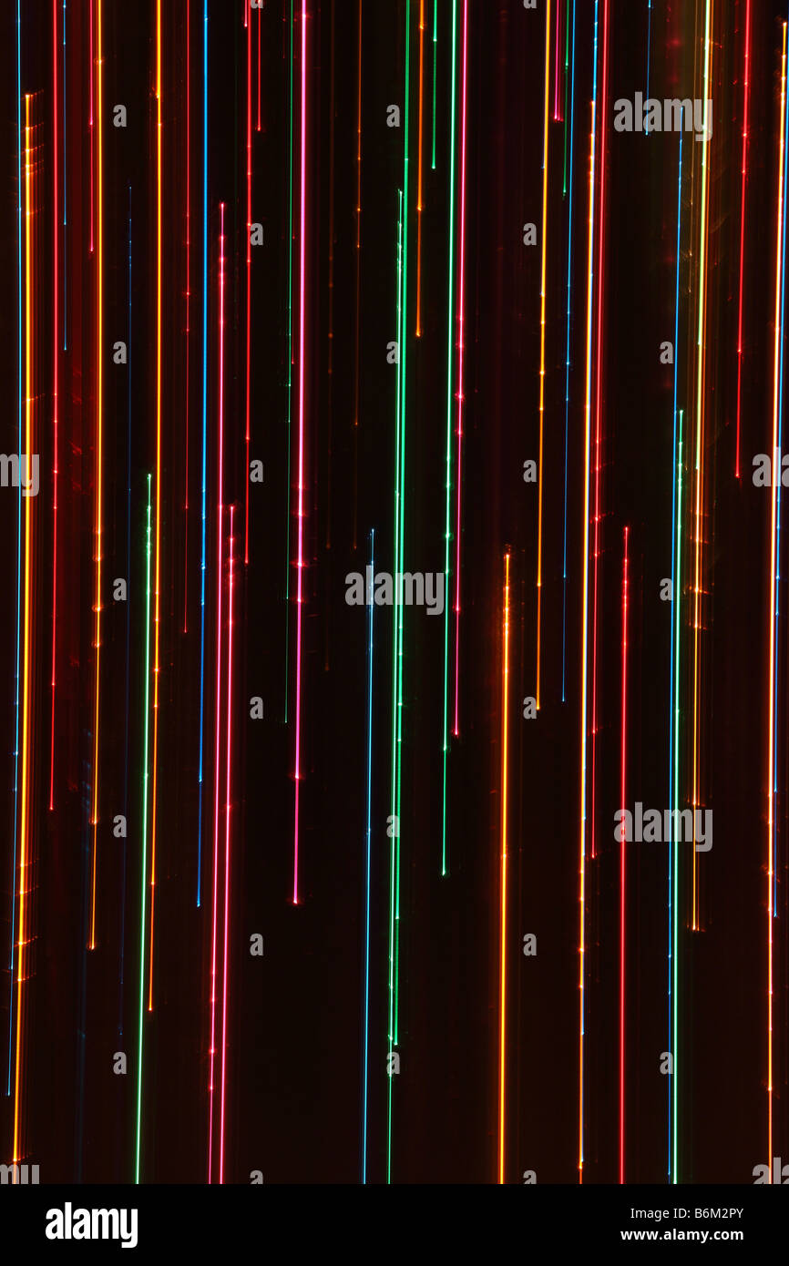 Graphic abstract multi coloured light trails against a black background Stock Photo