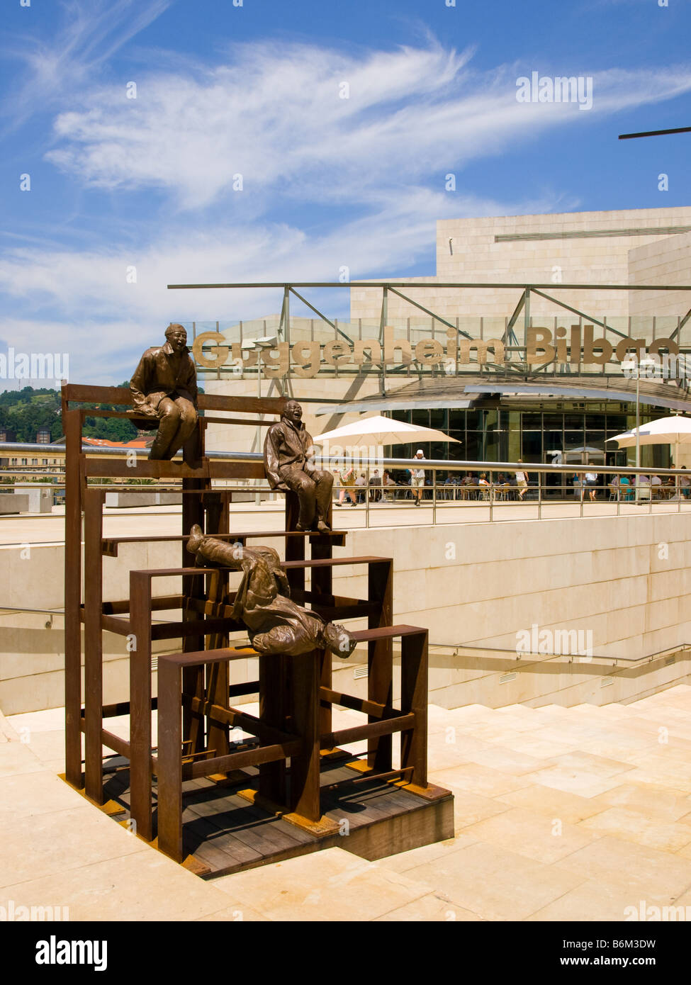 Juan Muñoz's 'Thirteen Laughing at Each Other (2001)' outside the entrance of the Guggenheim Museum Bilbao. Stock Photo