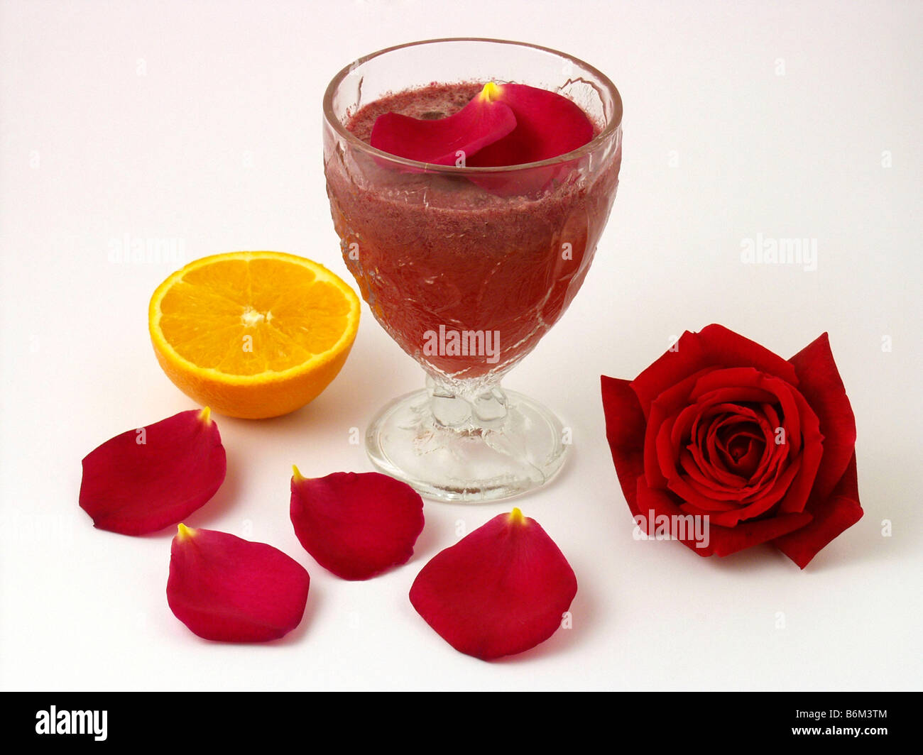 Edible flowers. Rose milkshake and orange juice Stock Photo Alamy
