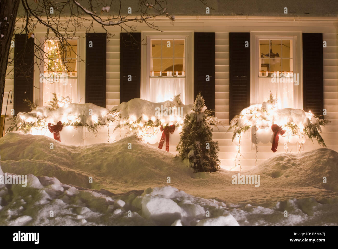 Christmas lights decorations on house in snow Mohawk Valley New York State Stock Photo