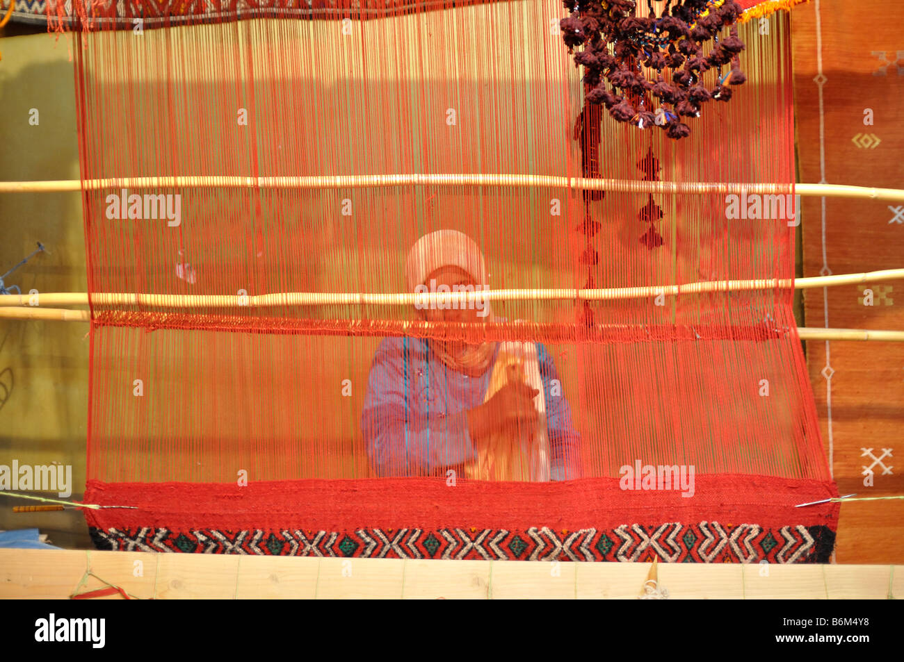 Berber woman weaving a carpet, Mococco Africa Stock Photo