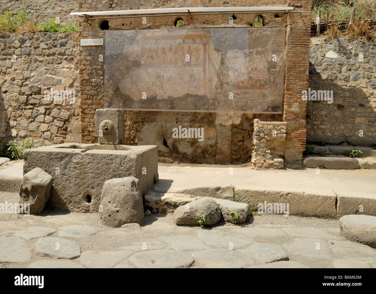 A fountain outside region IX and the public shrine, Compitum, of 12 gods. Pompeii, Campania, Italy, Europe. Stock Photo