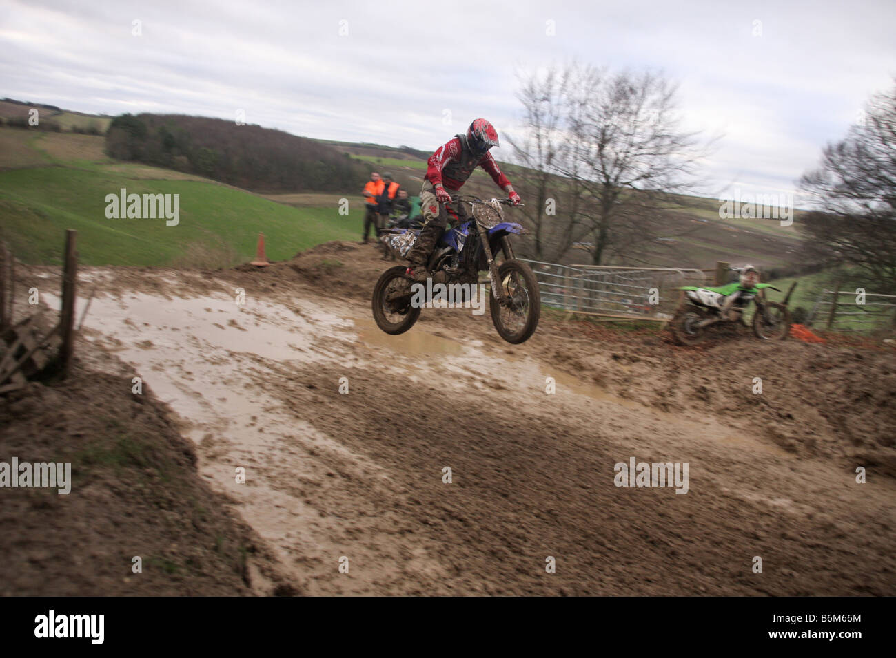 Motocross rider performing jump at dirt track Stock Photo - Alamy