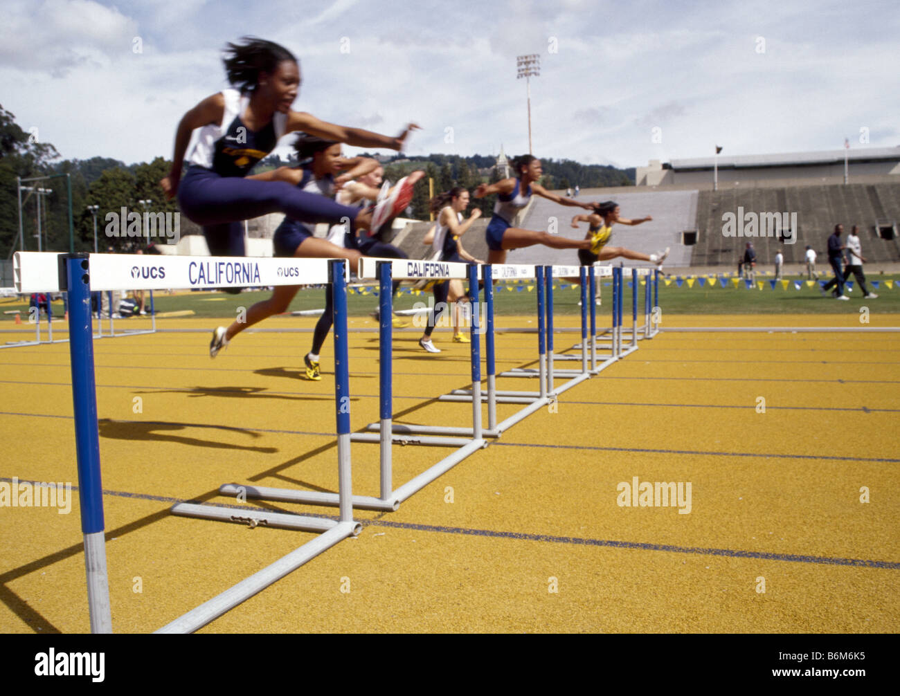Female athletes practice racing hurdles at UC Berkeley. Stock Photo