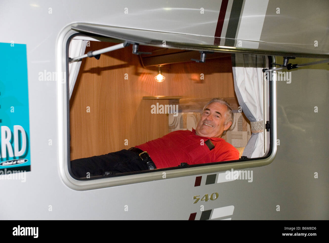 man testing bed in caravan Stock Photo - Alamy