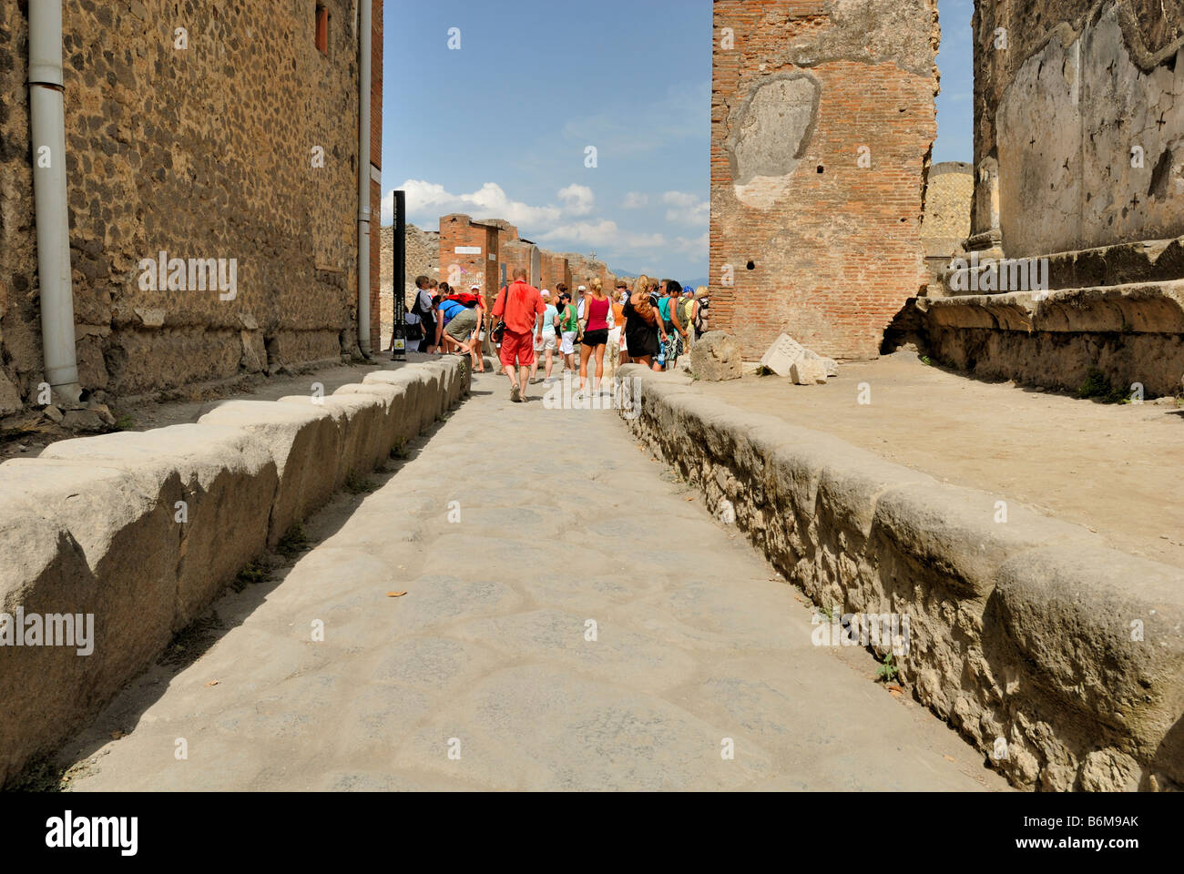 A fine street view to Vicolo dei Soprastanu, Vico dei Soprastanti. There is not much sun shade in summer time, Pompeii, Italy. Stock Photo