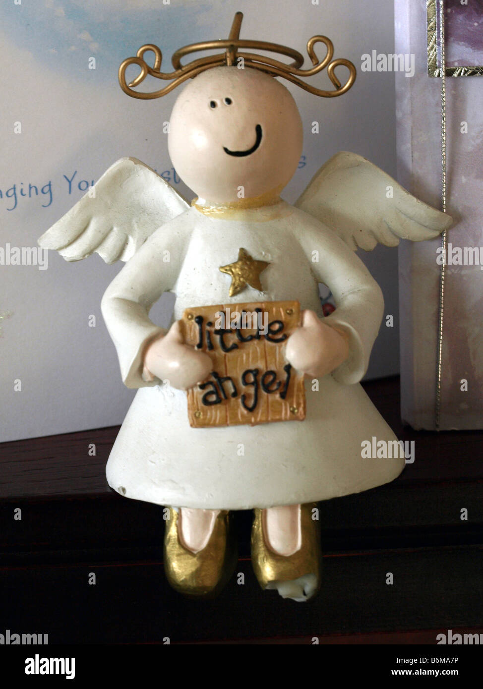 A little angel ornament,sitting in front of Christmas cards. Stock Photo