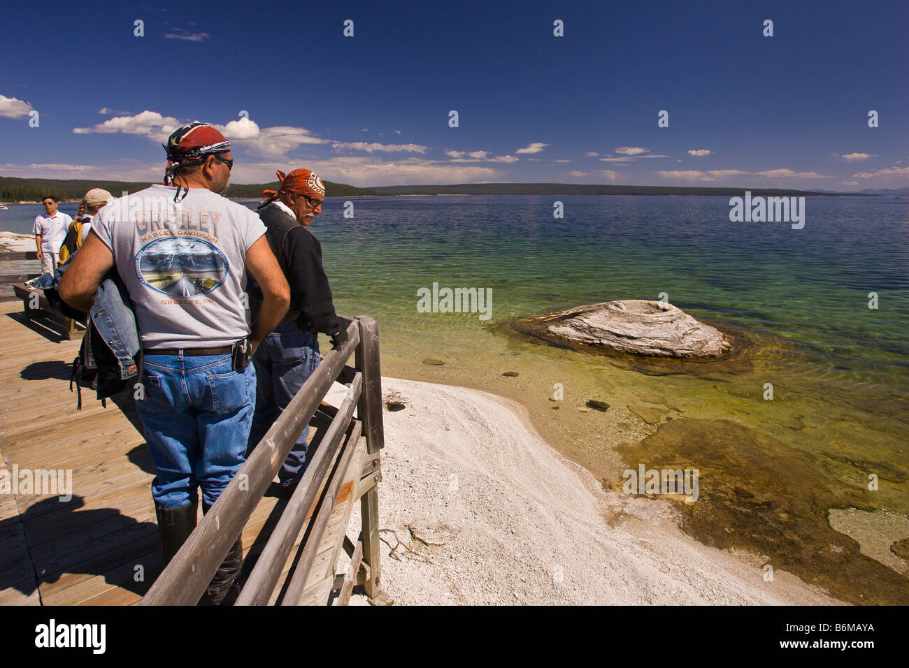 YELLOWSTONE NATIONAL PARK WYOMING USA Bikers visit Fishing Cone in the West Thumb Geyser Basin on the shore of Lake Yellowstone Stock Photo