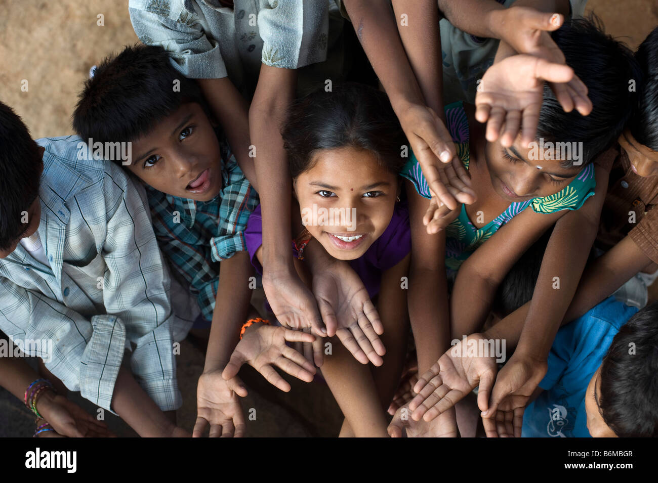 Indian children playing together huddled in a group. Andhra Pradesh, India Stock Photo