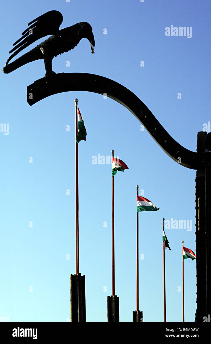 Silhouette of a raven sculpture and flagpoles on a gate in the palace in Budapest, Hungary Stock Photo