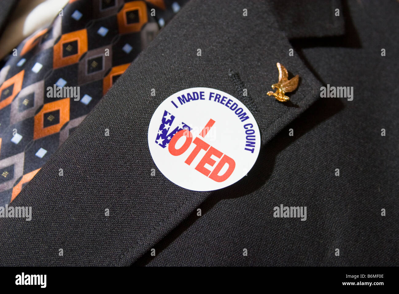 I Voted sticker on the lapel of a man's business suit Stock Photo