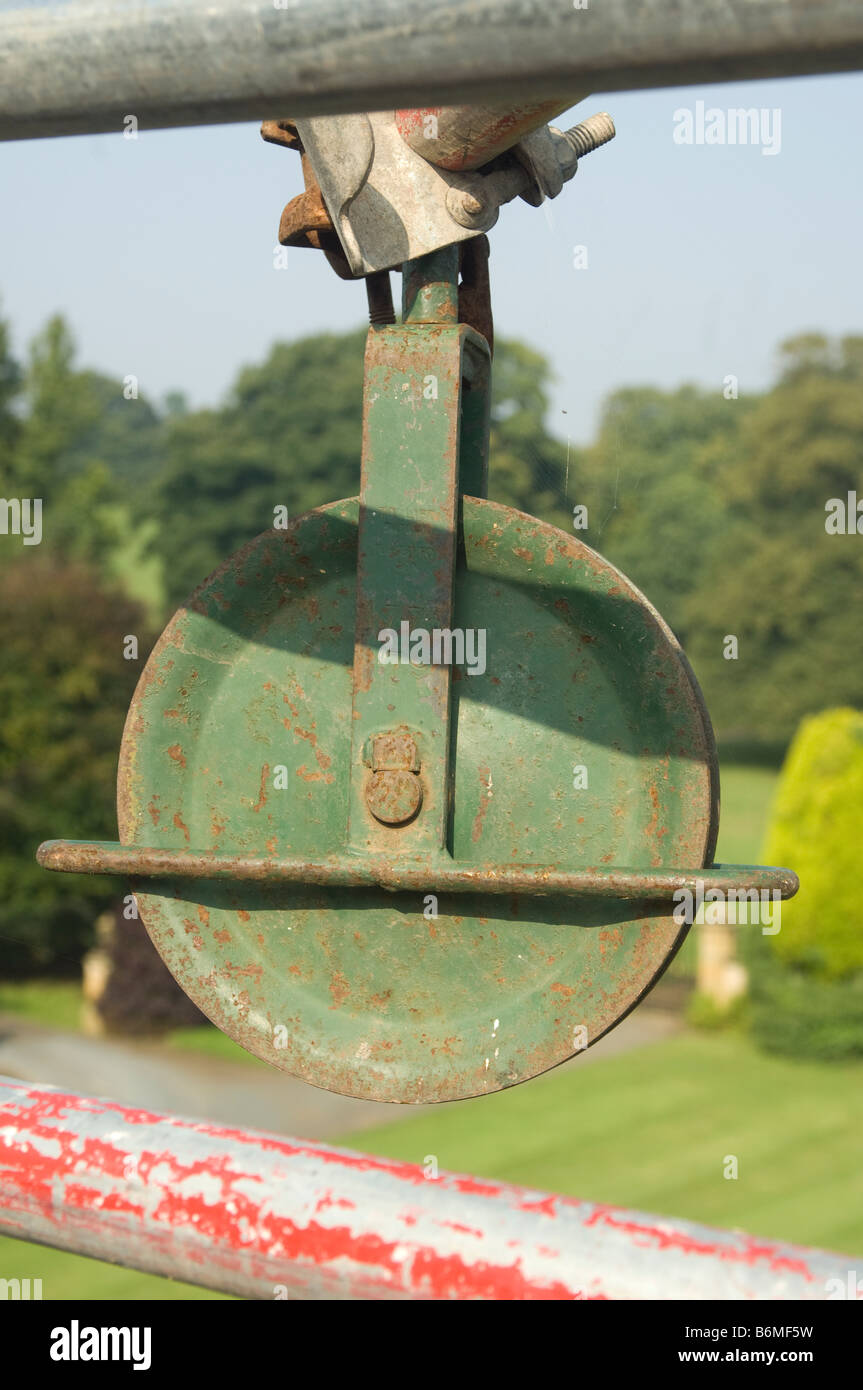 Rope pulley or hoist erected on scaffold bar in preparation for building work on traditional roof Stock Photo