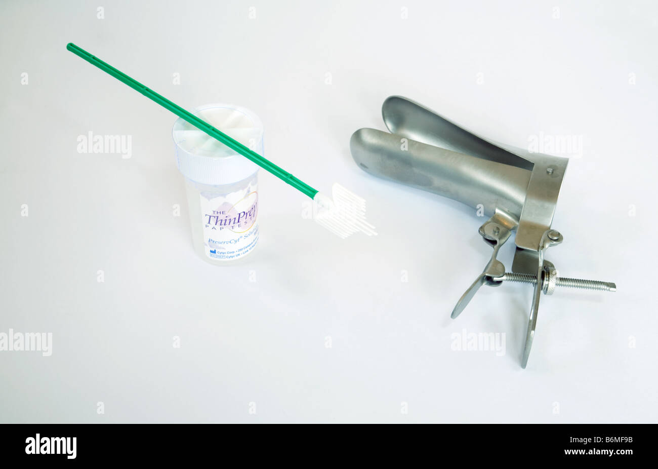 Instruments needed for a cervical smear test ; a  Speculum, smear brush and liquid preservative; UK Stock Photo