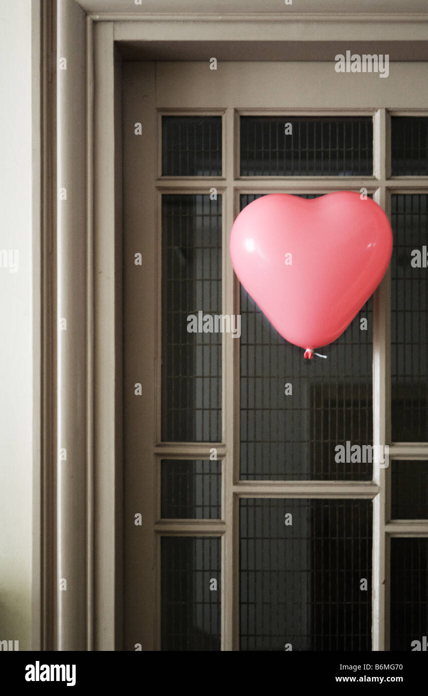 Heart shaped balloon on a door. Stock Photo