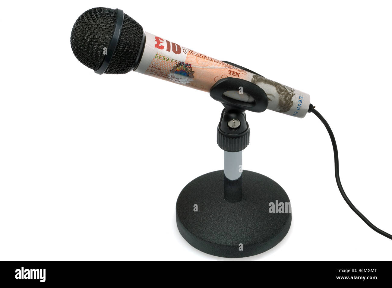 Money talks concept image of a ten pound note around a tabletop microphone isolated on a white background Stock Photo