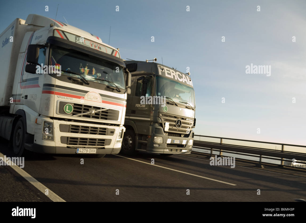 HGV UK; Two articulated lorries or HGVs overtaking on the M25 motorway in Dartford, Kent UK Stock Photo
