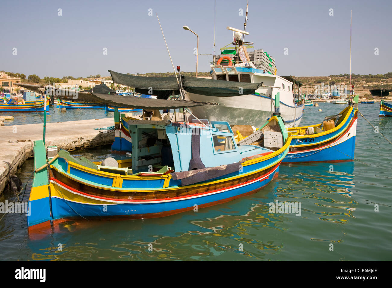Luzzu fishing boats moored in Marsaxlokk Harbour, Marsaxlokk, Malta Stock Photo