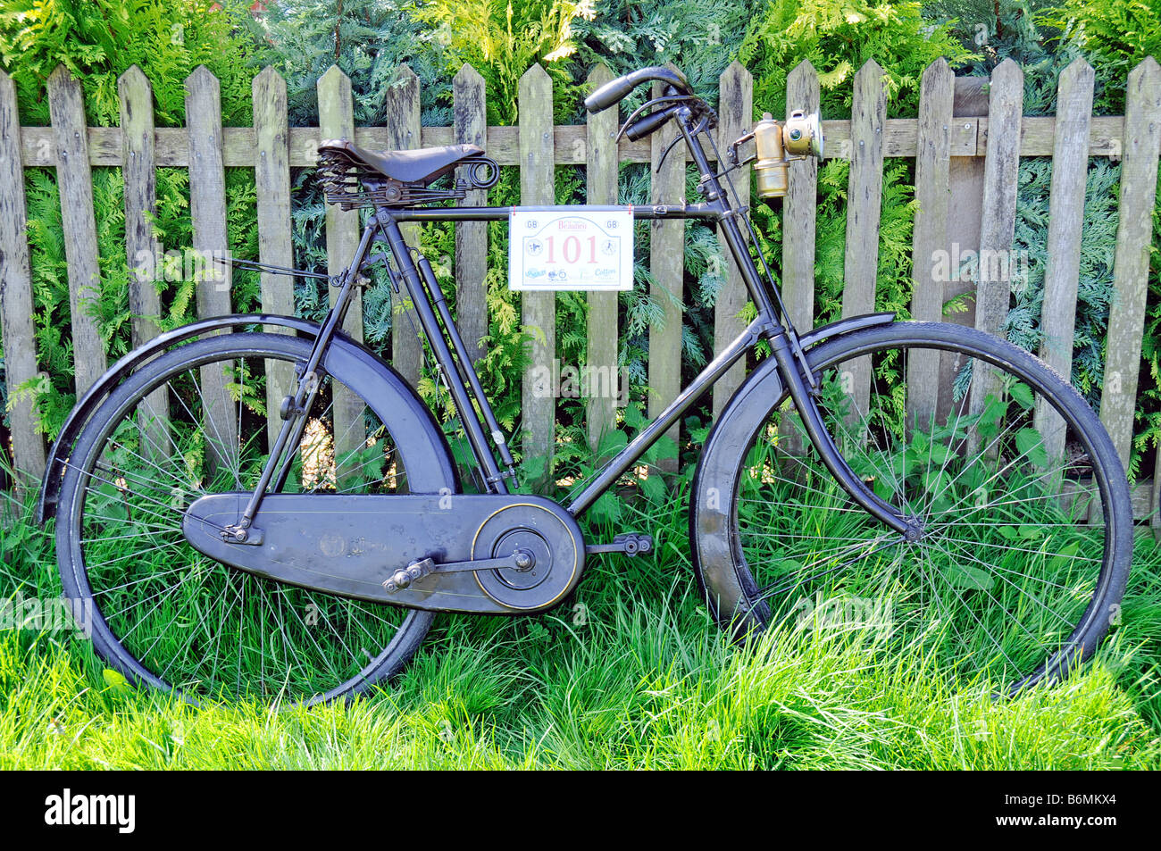 Veteran cycles at Buckler s Hard Beaulieu Hants an old bike leaning against a picket fence Stock Photo