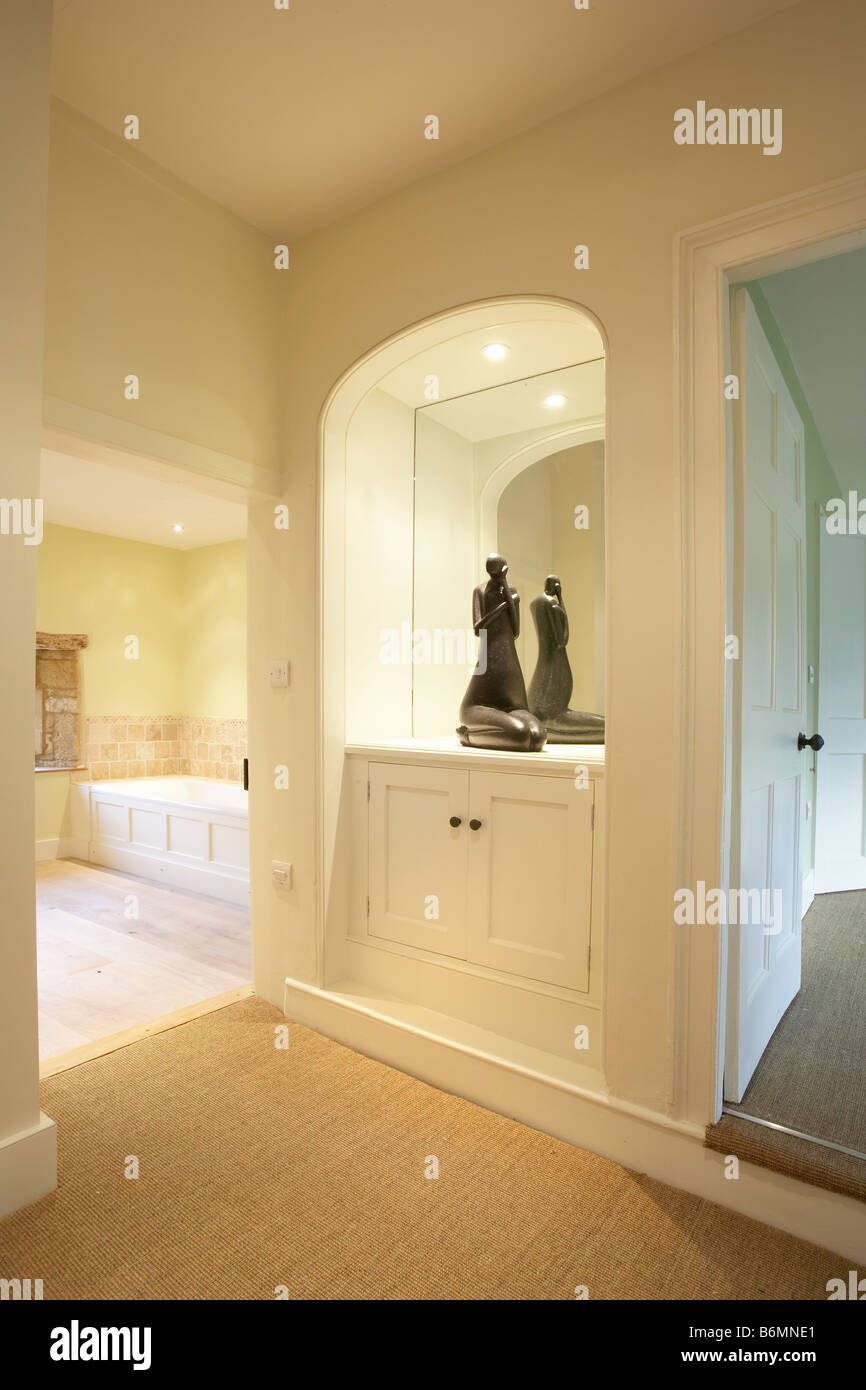 Hallway landing alcove sculpture mirror cupboard doorway seagrass Stock