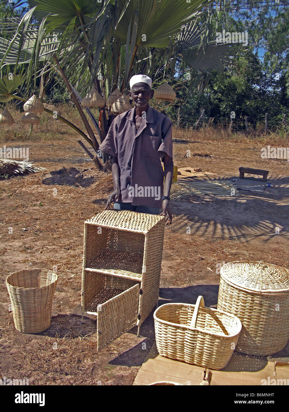 Local basket maker with his goods in The Gambia, West Africa Stock