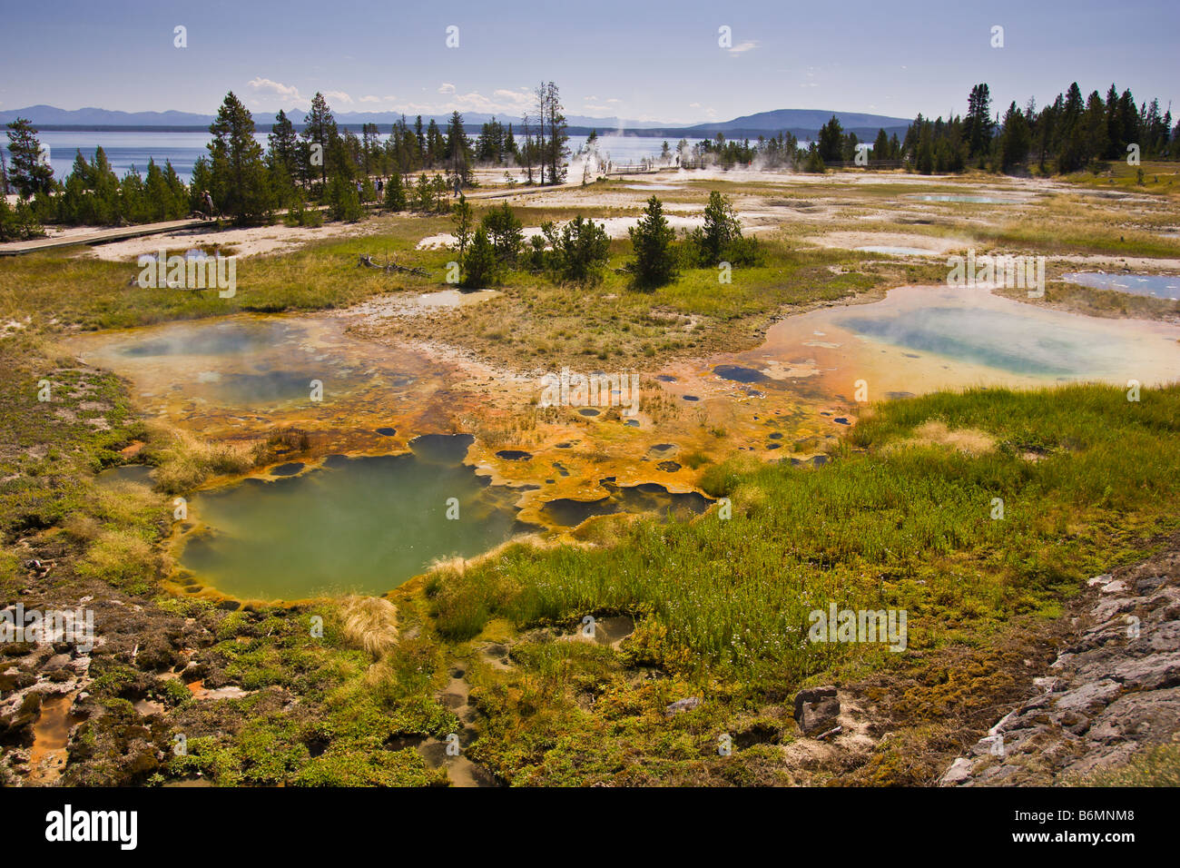 YELLOWSTONE NATIONAL PARK, WYOMING, USA - West Thumb Geyser Basin, and Yellowstone Lake in distance. Stock Photo