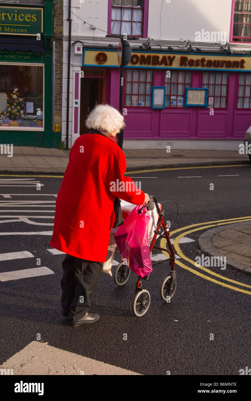 Old lady walking zimmer frame hi-res stock photography and images - Alamy