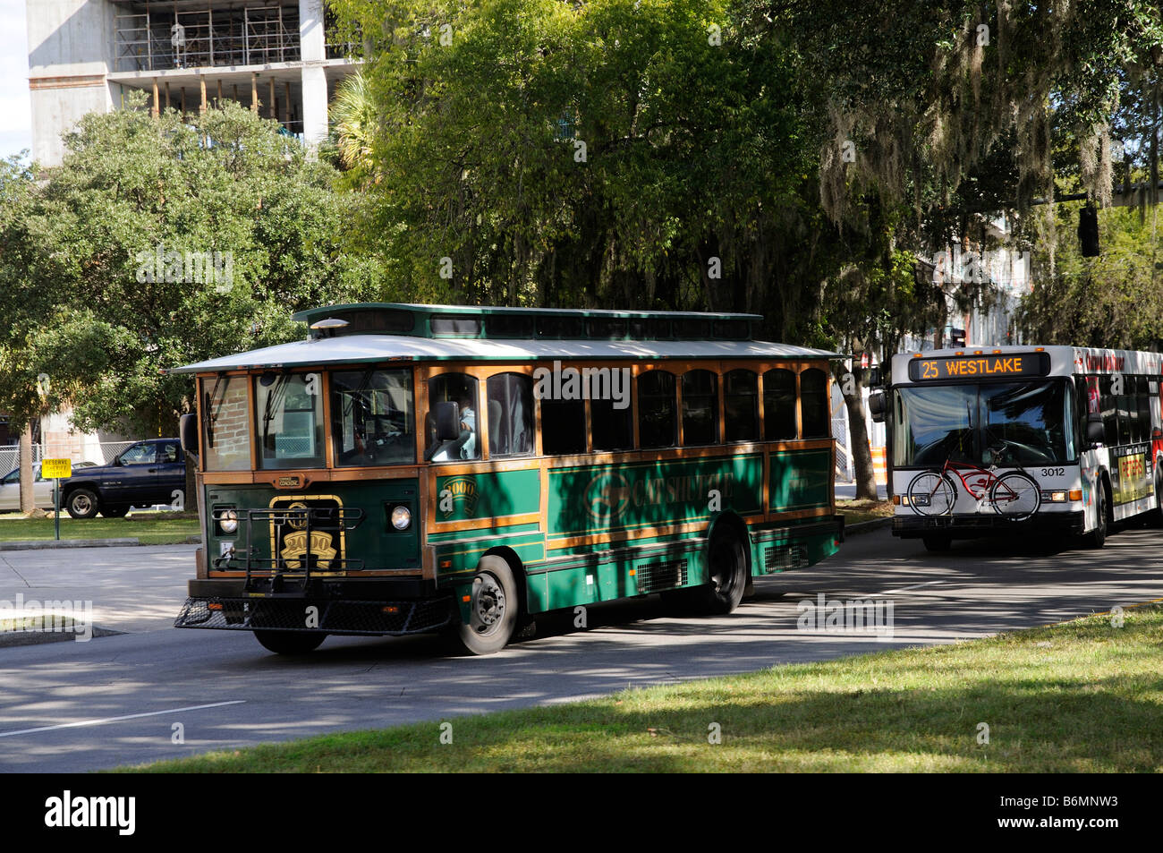 Trolley tour bus in the historic district of Savannah Georgia USA Following is a regular bus Stock Photo