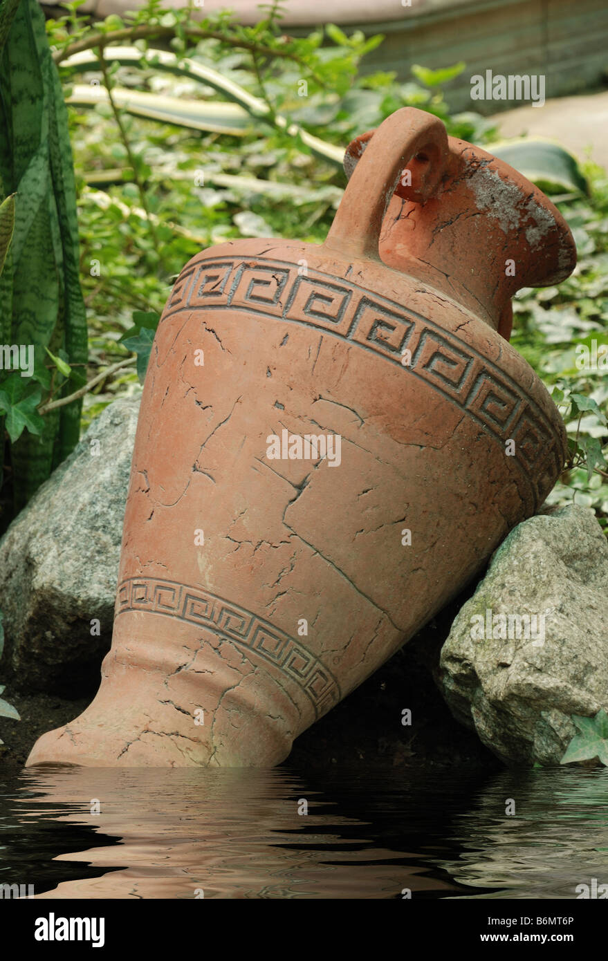 Ancient amphora An ancient clay vessel among stones Stock Photo