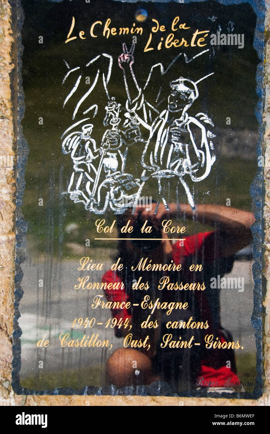 Reflection of a photographer taking a picture of a Chemin de la liberte plaque Homage to the people who fleed from the nazis fro Stock Photo