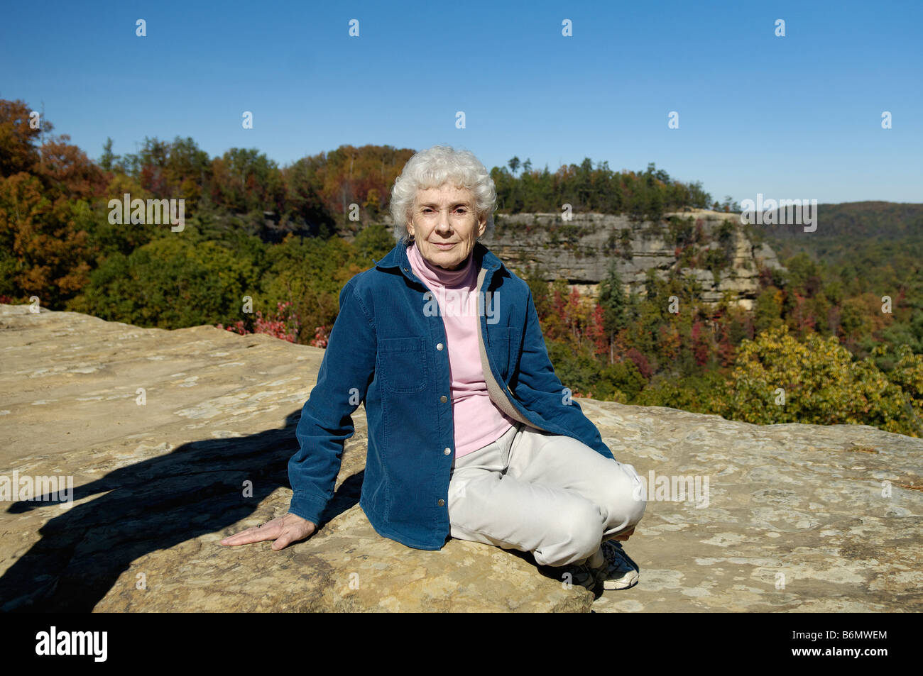 Senior Woman on Top of Natural Bridge in Natural Bridge State Park Kentucky Stock Photo