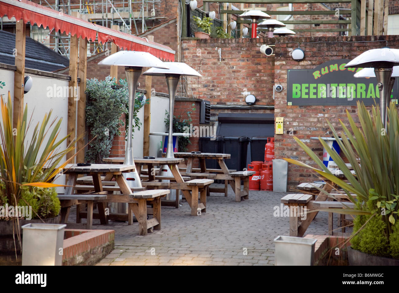 gas heaters and timber trestle tables in a pub's outside beer garden Stock Photo