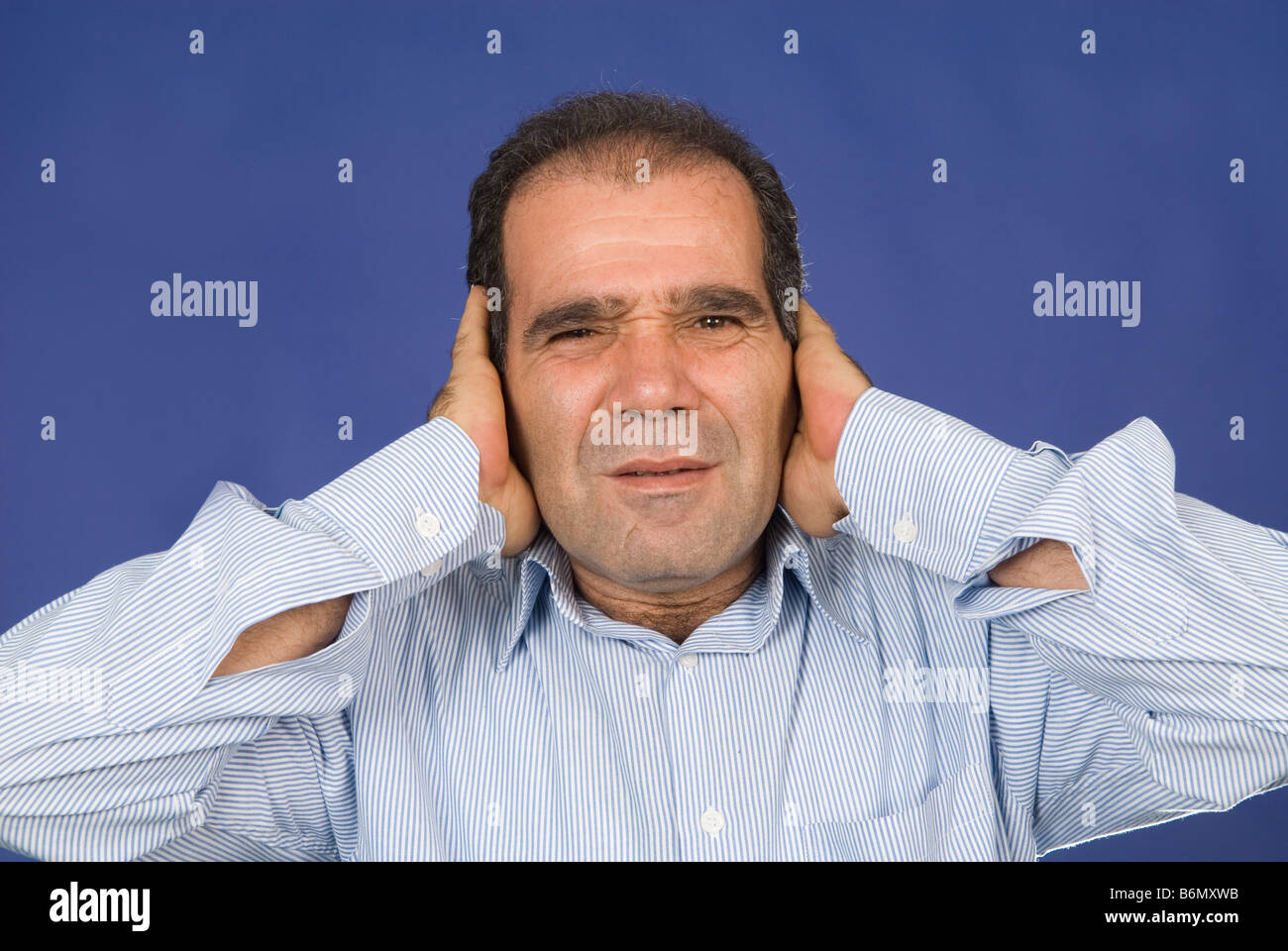 Man covering ears with hands Stock Photo Alamy
